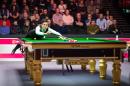 Hong Kong snooker player Marco Fu plays a shot in 2015
