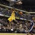 Indiana Pacers' George flies past the basket after dunking the ball in front of Memphis Grizzlies' Arthur during their NBA basketball game in Indianapolis