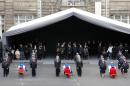 The coffins of the three police officers killed in the attacks are placed in the courtyard of the Paris Police headquarters during a ceremony to pay tribute, in Paris, France, Tuesday, Jan. 13, 2015. (AP Photo/Francois Mori, pool)