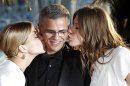 Actress Lea Seydoux, left, director Abdellatif Kechiche, centre, and Adele Exarchopoulos pose with the Palme d'Or award for the film La Vie D'Adele during a photo call after an awards ceremony at the 66th international film festival, in Cannes, southern France, Sunday, May 26, 2013. (AP Photo/Lionel Cironneau)