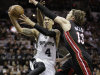 San Antonio Spurs' Danny Green (4) shoots between Miami Heat's Mario Chalmers, rear, and Mike Miller (13) during the first half at Game 5 of the NBA Finals basketball series, Sunday, June 16, 2013, in San Antonio. (AP Photo/Eric Gay)