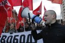 Left front opposition movement leader Sergei Udaltsov leads his supporters as they mark the anniversary of the 1917 Bolshevik revolution in Moscow