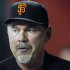 San Francisco Giants manager Bruce Bochy looks on from the dugout after pulling starting pitcher Eric Surkamp during the first inning of a baseball game against the Arizona Diamondbacks Saturday, Sept. 24, 2011, in Phoenix. (AP Photo/Ross D. Franklin)