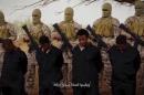 Islamic State militants stand behind what are said to be Ethiopian Christians in Wilayat Fazzan, in this still image from an undated video made available on a social media website