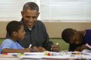 Obama smiles as he works on a literacy project with children during a day of service at the Boys & Girls Club in Washington