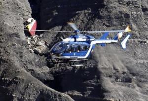 A French Gendarmerie rescue helicopter flies over the debris of the Airbus A320 at the site of the crash, near Seyne-les-Alpes, French Alps