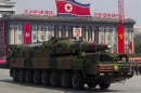 FILE - In this April 15, 2012 file photo, a North Korean vehicle carrying a missile passes by during a mass military parade in Pyongyang's Kim Il Sung Square to celebrate the centenary of the birth of the late North Korean founder Kim Il Sung. The enormous, 16-wheel truck used to carry the missile, likely came from China in a possible violation of U.N. sanctions meant to rein in Pyongyang's missile program, experts say. Pinning a sanctions-busting charge on Beijing would be difficult, however, because it would be hard to prove that Beijing provided the technology for military purposes or even that it sold the vehicle directly to North Korea, the experts said. (AP Photo/David Guttenfelder, File)