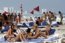 In this March 10, 2012 photo, people hang out on the beach during spring break in Cancun, Mexico. While American tourism to Mexico slipped a few percentage points last year, the country remains by far the biggest tourist destination for Americans, according to annual survey of bookings by the largest travel agencies. (AP Photo/Israel Leal)