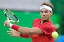 Spain's Rafael Nadal returns the ball to Brazil's Thomaz Bellucci during their men's singles quarter-finals match on August 12, 2016 in Rio