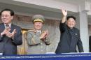 North Korean leader Kim Jong Un (R), accompanied by his uncle Jang Song Thaek (L), waves as he inspects a parade of the Worker-Peasant Red Guards at Kim Il-Sung Square in Pyongyang, on September 9, 2013