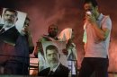 Supporters of deposed Egyptian President Mohamed Mursi carry posters of Mursi during clashes on the Sixth of October Bridge over the Ramsis square area in central Cairo