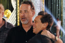 Actor Tom Hanks, left, and Brian Grazer, producer of the 84th Academy Awards, embrace during rehearsals for Sunday's show Saturday, Feb 25, 2012 in Los Angeles. (AP Photo/Chris Carlson)