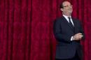 France's President Hollande reacts during a ceremony where he named French singer and actress Renaud "Grand Officier de la Legion d'Honneur" at the Elysee Palace in Paris