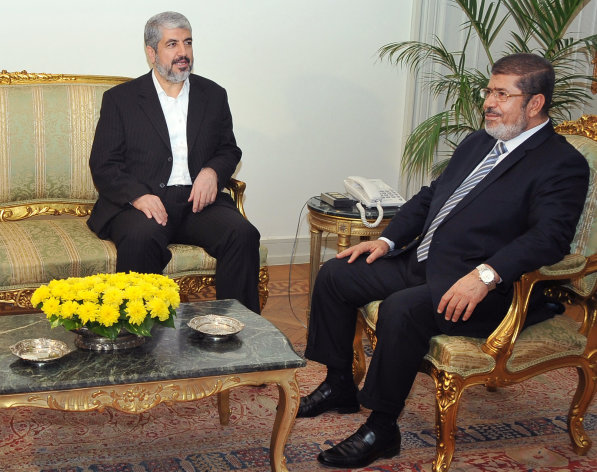 In this image provided by the Egyptian President, Hamas leader Khaled Mashaal, left, meets with Egyptian President Mohammed Morsi at the Presidential Palace in Cairo, Sunday, Nov. 18, 2012. About 500 Egyptian activists have crossed into Gaza to deliver medical supplies and show support for Palestinians facing an Israeli offensive. Morsi, comes from the Muslim Brotherhood, the parent group of Hamas and has met with Hamas leaders in Cairo. (AP Photo/Egyptian Presidency)