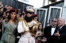 Sacha Baron Cohen, right, and guest arrive before the 84th Academy Awards on Sunday, Feb. 26, 2012, in the Hollywood section of Los Angeles. (AP Photo/Matt Sayles)