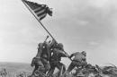 FILE - In this Feb 23, 1945 file photo, U.S. Marines of the 28th Regiment, 5th Division, raise the American flag atop Mt. Suribachi, Iwo Jima, Japan. The Marine Corps said Monday, May 2, 2016, that it has begun investigating whether it mistakenly identified one of the men shown raising the U.S. flag at Iwo Jima in one of the iconic images of World War II after two amateur history buffs began raising questions about the picture. The Marines announced its inquiry more than a year after Eric Krelle, a toy designer from Omaha, Neb., and Stephen Foley, who works at a building supply company in Wexford, Ireland, questioned the identity of one man. (AP Photo/Joe Rosenthal, File)