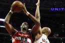 File photo of Washington Wizards' Jason Collins going to the basket against Chicago Bulls' Taj Gibson during the first half of their NBA basketball game in Chicago, Illinois