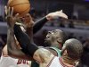 Boston Celtics forward Brandon Bass, center, drives to the basket against Chicago Bulls forward Carlos Boozer (5) and guard Kyle Korver (26) during the first half of an NBA basketball game in Chicago, Thursday, April 5, 2012. (AP Photo/Nam Y. Huh)
