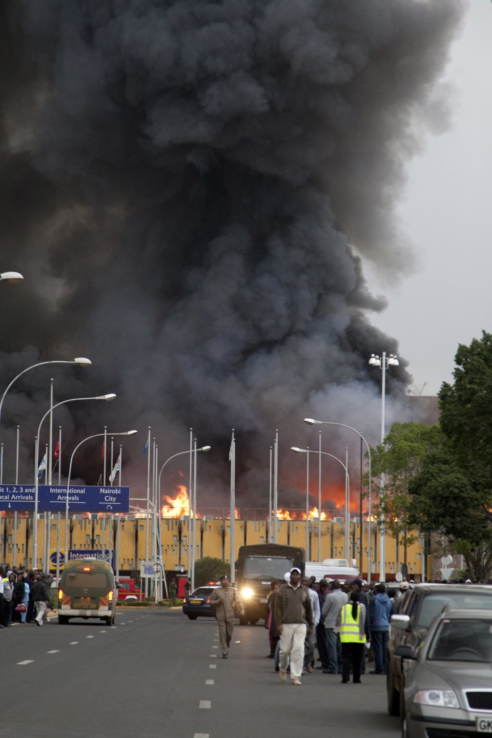 Black smoke billows from the Jomo Kenyatta International Airport in Nairobi, Kenya Wednesday, Aug. 7, 2013. The Kenya Airports Authority said the Kenya's main international airport has been closed until further notice so that emergency teams can battle the fire. (AP Photo/Sayyid Azim)