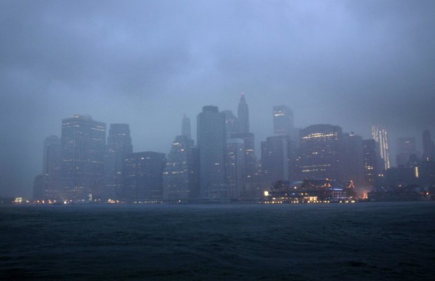 Lower Manhattan is seen amidst dark clouds in New York, Sunday, Aug. 28, 2011. Hurricane Irene bore down on a dark and quiet New York early Sunday, bringing winds and rapidly rising seawater that threatened parts of the city. The rumble of the subway system was silenced for the first time in years, the city all but shut down for the strongest tropical lashing since the 1980s. (AP Photo/Seth Wenig)
