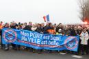 Shop owners and local business people hold a banner reading "My port is beautiful, My city is beautiful" during a demonstration in Calais to call attention to the impact that Europe's migrant crisis is having on their town's local economy, in Calais, northern France, Sunday, Jan. 24, 2016. Calais has become a flashpoint in Europe's migrant crisis as thousands of migrants seeking to cross into Britain camp out in squalid conditions and periodically wreak havoc on service at the port and nearby rail facilities. (Photo/Michel Spingler)