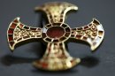 In this undated image made available by the University of Cambridge in England early Friday March 16, 2012, shows a cross. Archaeologists excavating near Cambridge have stumbled upon a rare and mysterious find, the skeleton of a 7th-Century teenager buried in an ornamental bed along with a gold-and-garnet cross, an iron knife and a purse of glass beads. There is very little known about this funerary practice, which one archaeologist, Alison Dickens, said would open a window of knowledge into the transitional period when the pagan Anglo-Saxons were gradually adopting Christianity. (AP Photo/University of Cambridge)