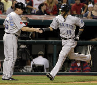 Toronto Blue Jays' Jose Bautista, right, is congratulated by third base coach Brian Butterfield as he rounds third after hitting a solo home run against the Cleveland Indians during the ninth inning of a baseball game, Thursday, July 7, 2011, in Cleveland. (AP Photo/Amy Sancetta)