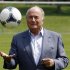 Sepp Blatter poses with a ball on a local soccer pitch in Zurich