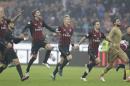 AC Milan's players celebrate their 1-0 win over Pescara at the end of a Serie A soccer match at the San Siro stadium in Milan, Italy, Sunday, Oct. 30, 2016. (AP Photo/Luca Bruno)