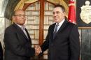 Tunisian President Moncef Marzouki shakes hands with Tunisia's Prime Minister-designate Mehdi Jomaa after Jomaa spoke during a news conference in Tunis