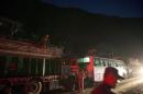 People ride on buses as traffic is affected by a landslide caused by an earthquake, in Kurintar, Nepal