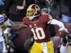 Washington Redskins quarterback Robert Griffin III (10) celebrates his touchdown during the second half of an NFL football game against the Dallas Cowboys on Sunday, Dec. 30, 2012, in Landover, Md. (AP Photo/Nick Wass)