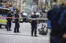 Policemen and a bomb robot are seen in a cordoned-off area in the old town of central Stockholm