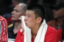 Rockets point guard Jeremy Lin sits on the bench as time runs out against the Lakers during the second half of their NBA basketball game in Los Angeles
