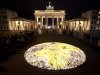 About 5000 candles arrange to a globe lights in front of the Brandenburg Gate prior to the landmark switched off the lights to mark 'Earth Hour'  in  Berlin, Saturday, March 31, 2012. Earth Hour takes place worldwide at 8.30 p.m. local time and is a global call to turn off lights for 60 minutes in a bid to highlight the global climate change. (AP Photo/Markus Schreiber)