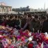 North Koreans gather to lay flowers on a stage in front of a large portrait of the late Kim Jong Il as they pay their respects on the first day of the Lunar New Year holiday at Kim Il Sung Square in Pyongyang Monday, Jan. 23, 2012. Pyongyang residents said they were encouraged to celebrate the traditional holiday as they usually do, despite the death of Kim Jong Il, only the second leader North Koreans have known since the nation was founded in 1948. (AP Photo/David Guttenfelder)