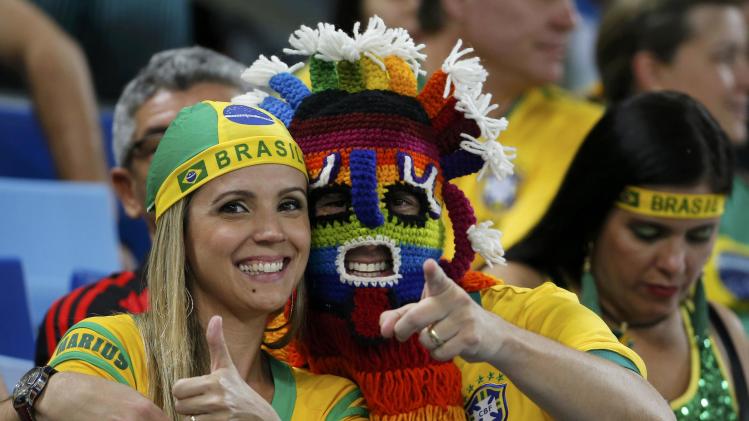 Fans of Brazil wait for the start of the 2014 World Cup Group F soccer match between Nigeria and Bosnia at the Pantanal arena in Cuiaba