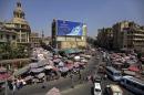 In this Wednesday, Sept. 25, 2013 photo, Egyptians crowd a shopping at a market in Cairo, Egypt. Egypt's capital has long been proud of its nickname, 