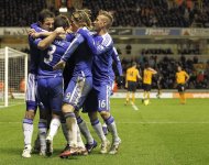 Chelsea's English midfielder Frank Lampard (L) celebrates scoring his winning goal with teammates during the English Premier League football match between Wolverhampton Wanderers and Chelsea at Molineux Stadium in Wolverhampton. Chelsea won 2-1. (AFP Photo/Ian Kington)