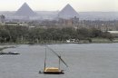 FILE - In this Tuesday, Jan. 22, 2013 file, a traditional felucca sailing boat carries a cargo of hay as it transits the Nile river passing the Pyramids of Giza in Cairo, Egypt. Politicians meeting with Egyptian President Mohammed Morsi have proposed hostile acts against Ethiopia to try and stop it from building a massive dam over the River Nile. Some of the politicians attending Monday's meeting with President Mohammed Morsi were not it was carried live on television. (AP Photo/Amr Nabil, File)