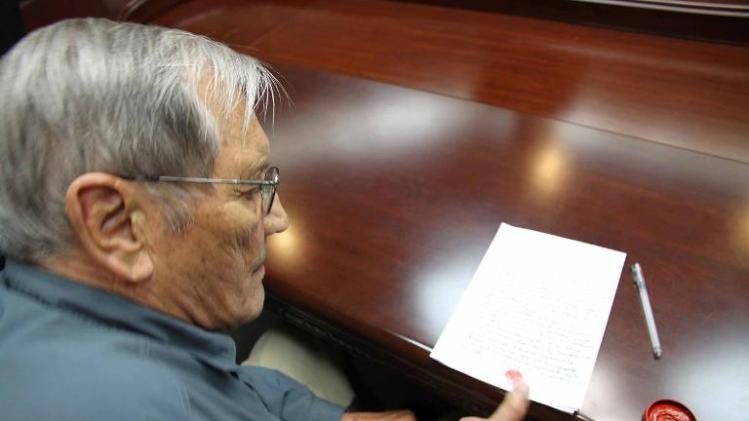 This photo taken on November 9, 2013 and released on Novermber 30, 2013 by North Korea's official Korean Central News Agency (KCNA) shows US citizen Merrill Newman inking his thumbprint onto a written apology