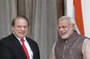India's Prime Minister Modi and his Pakistani counterpart Sharif smile before the start of their bilateral meeting in New Delhi