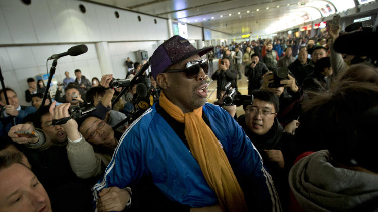 Former NBA basketball player Dennis Rodman is followed by journalists as he arrives at the Capital International Airport in Beijing from Pyongyang, Monday, Jan. 13, 2014. Rodman has checked into an undisclosed alcohol rehabilitation center to treat his long-time struggle with alcoholism, his agent says. (AP Photo/Alexander F. Yuan)