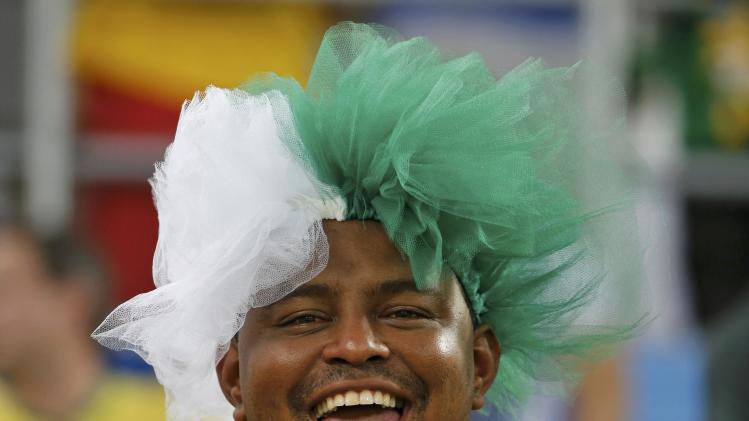 A Nigeria fan waits for the start of the 2014 World Cup Group F soccer match between Nigeria and Bosnia at the Pantanal arena in Cuiaba
