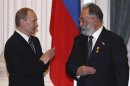 Russia's President Putin applauds after he decorated Russian State Duma member Chilingarov with Hero's Golden Star during ceremony in Moscow