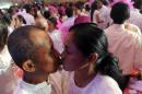 Couples kiss during a free mass wedding in Manila of February 14, 2014