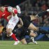 New Zealand's Daniel Carter, bottom, and Sonny Bill Williams tackle Tonga's Andre Ma'ilei during their Rugby World Cup game at Eden Park in Auckland, New Zealand, Friday, Sept. 9, 2011.  (AP Photo/Christophe Ena)