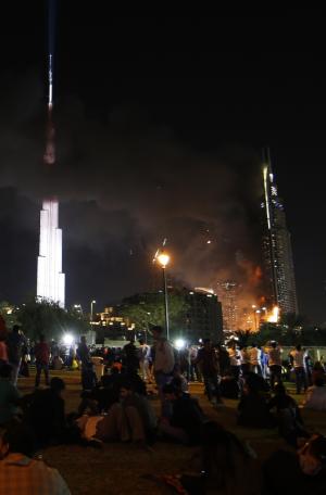 People watch the Address Downtown hotel burning in&nbsp;&hellip;