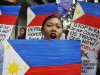 Women protesters shouts slogans as they picket the U.S. Embassy in Manila Friday Feb. 10, 2012 in the Philippines to protest the alleged shift of focus in U.S. foreign policy from Iraq and Afghanistan to the Asia Pacific under the so-called "Pacific Century." The protesters assailed the Philippine government for setting up talks with the U.S. counterpart regarding possible increase in deployment of U.S. troops in the country. (AP Photo/Bullit Marquez)