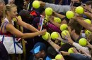 Russia's Maria Sharapova signs autographs following her victory over Israel's Shahar Peer